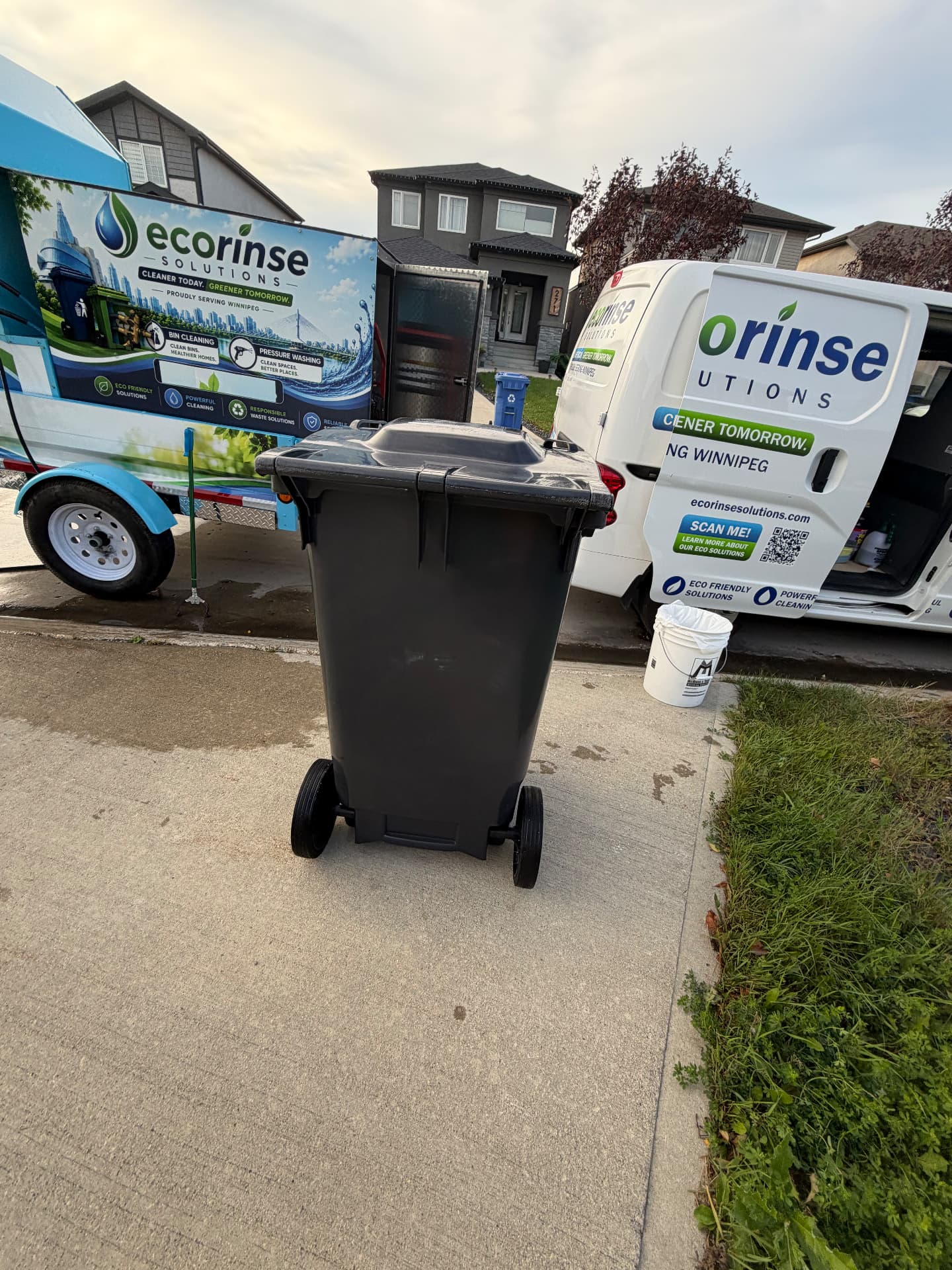 Clean residential bin beside the EcoRinse service van and cleaning trailer